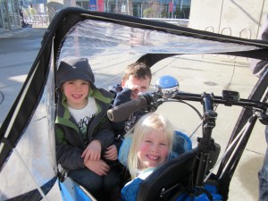 Loading up: three kids in the box of our Bullitt bicycle.