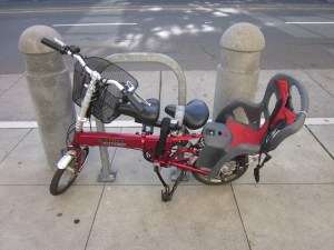 That's a rear child seat, a double front saddle, and a front cargo basket on a folding bike. Damn!