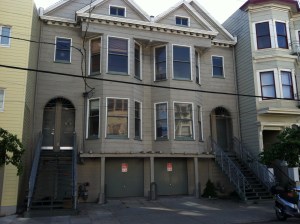 Double doors on each side of this building, four flats