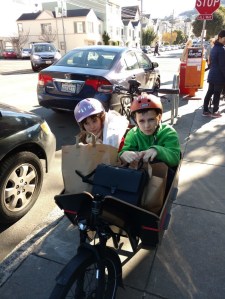 Here we are loaded up: two kids, groceries, and my stuff.