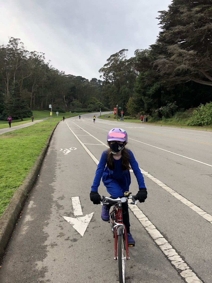 Girl riding bicycle in Golden Gate Park